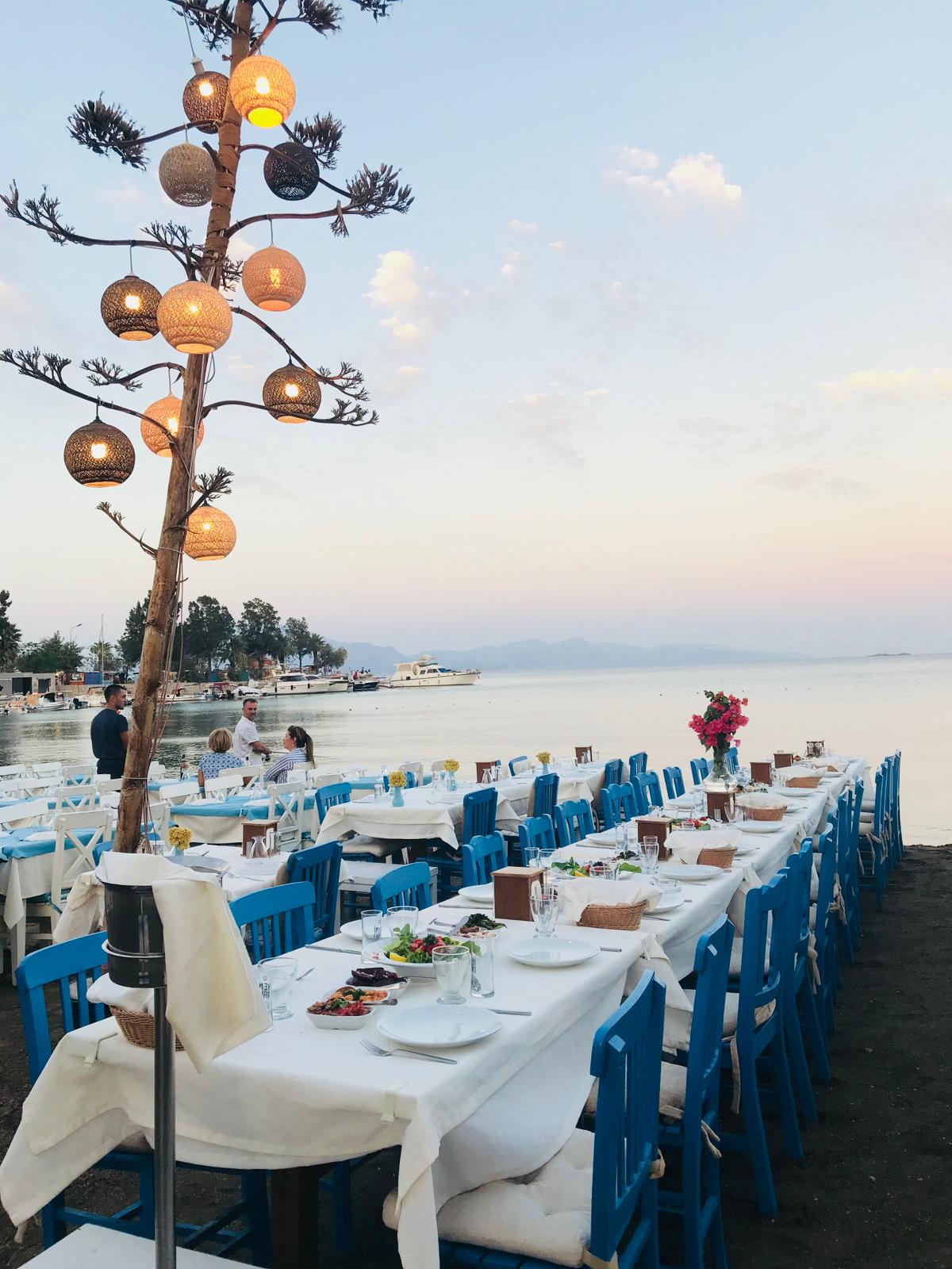 Ada Balik Datca gunbatimi, deniz kenarinda sofra